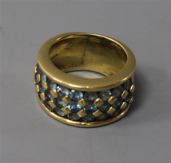 An 18ct gold and blue topaz? pave set ring, size L.